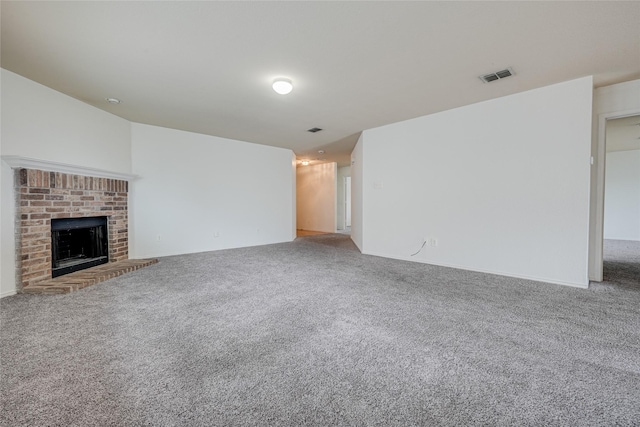 unfurnished living room with visible vents, light carpet, and a fireplace