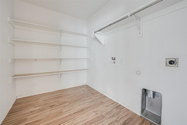 laundry room with gas dryer hookup, washer hookup, laundry area, wood finished floors, and electric dryer hookup