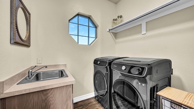 laundry area featuring a sink, dark wood-style floors, separate washer and dryer, baseboards, and laundry area