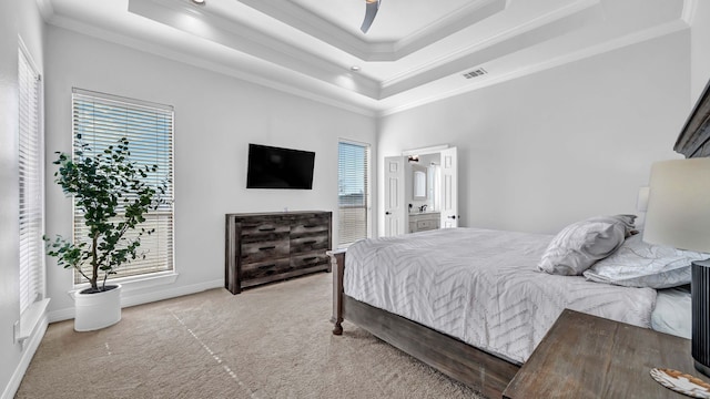 carpeted bedroom featuring visible vents, crown molding, ceiling fan, baseboards, and a tray ceiling