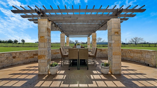 view of patio with a pergola, outdoor dining area, and fence