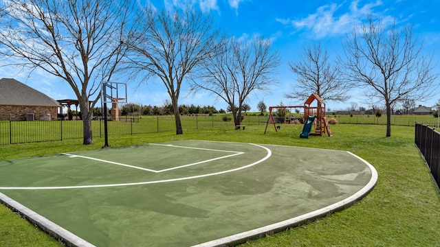 view of basketball court with playground community, a yard, community basketball court, and fence