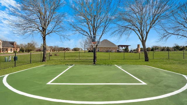 view of basketball court with a lawn, community basketball court, and fence