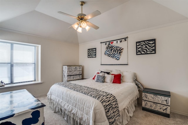 carpeted bedroom featuring ceiling fan, ornamental molding, and vaulted ceiling