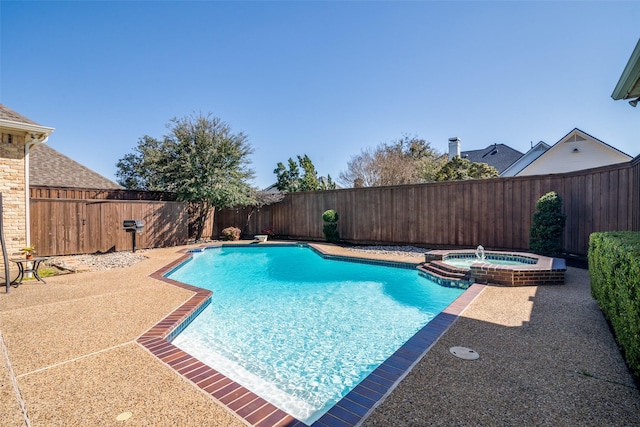 view of pool with a patio area, a fenced backyard, and a pool with connected hot tub