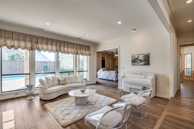 living room with visible vents, baseboards, ornamental molding, recessed lighting, and wood finished floors