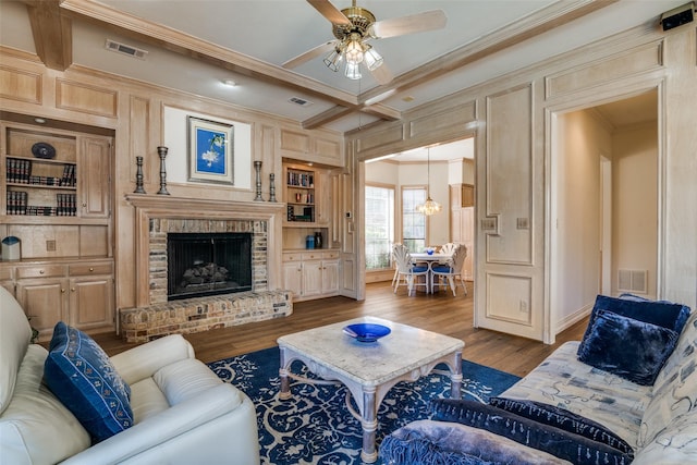 living room with visible vents, wood finished floors, and crown molding