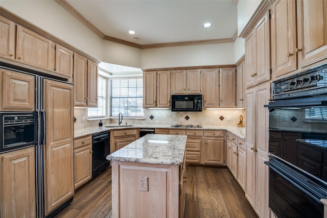 kitchen with a warming drawer, black appliances, light brown cabinetry, light stone counters, and a sink