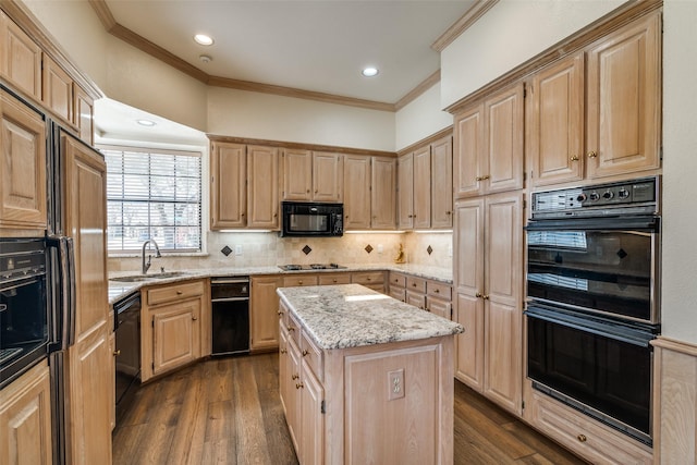 kitchen with black appliances, light brown cabinetry, and a sink