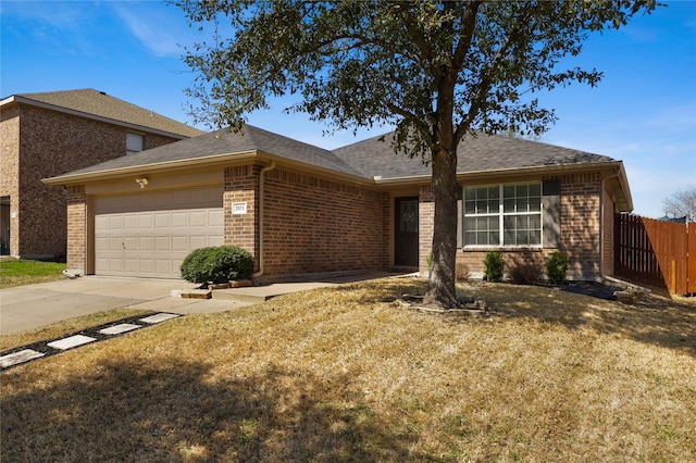 single story home featuring driveway, fence, an attached garage, a shingled roof, and brick siding