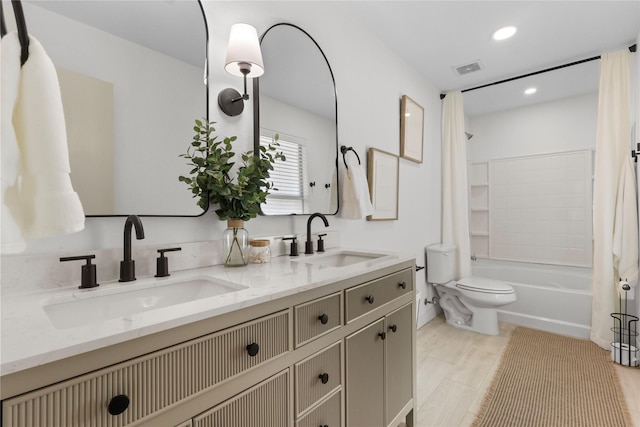 bathroom with a sink, toilet, shower / bath combo, and double vanity