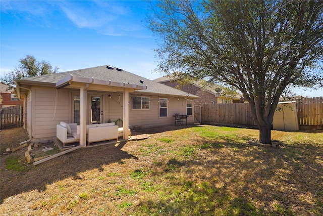rear view of house with a lawn, a fenced backyard, and a patio area