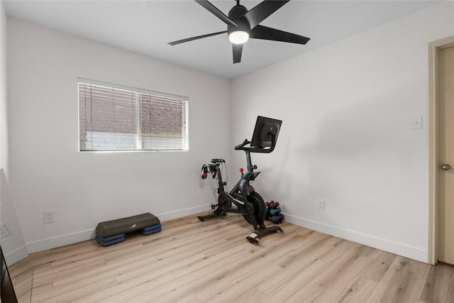 workout room with ceiling fan, baseboards, and wood finished floors