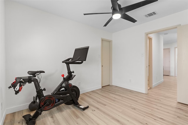 exercise room featuring visible vents, a ceiling fan, baseboards, and wood finished floors