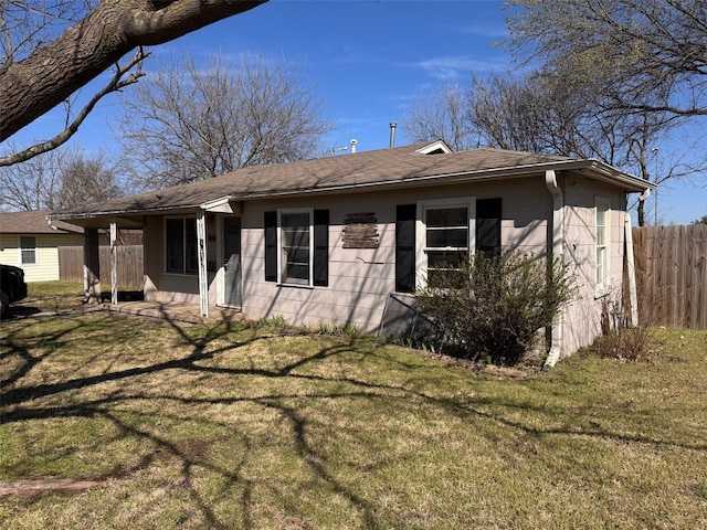 exterior space with a lawn and fence