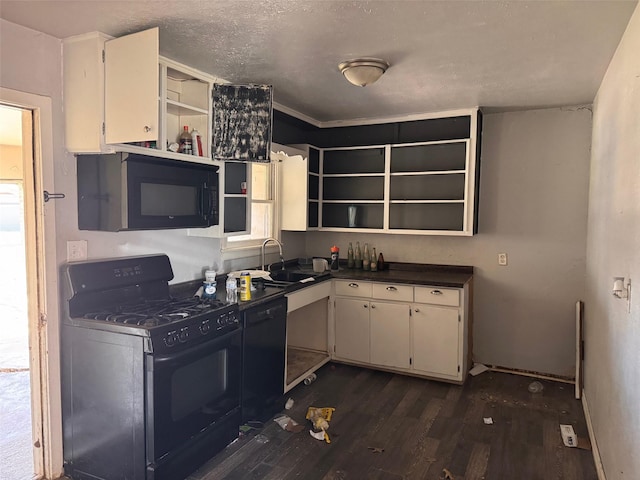 kitchen featuring dark countertops, a sink, black appliances, and open shelves