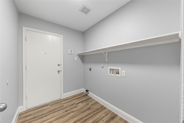 laundry area featuring wood finished floors, visible vents, gas dryer hookup, hookup for an electric dryer, and laundry area