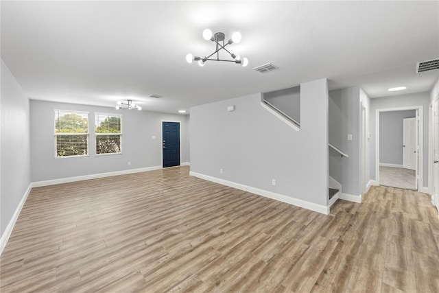 interior space featuring visible vents, baseboards, stairway, light wood-style floors, and an inviting chandelier