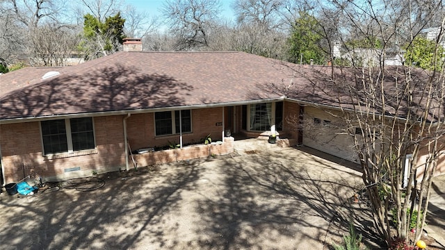 single story home with roof with shingles, a chimney, a garage, crawl space, and brick siding