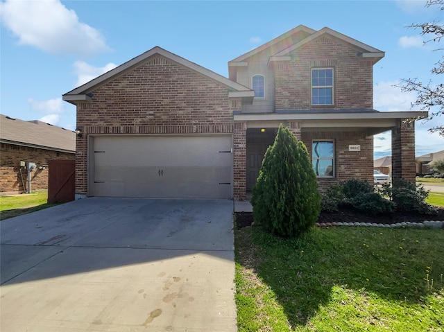 traditional home with a front lawn, a garage, brick siding, and driveway