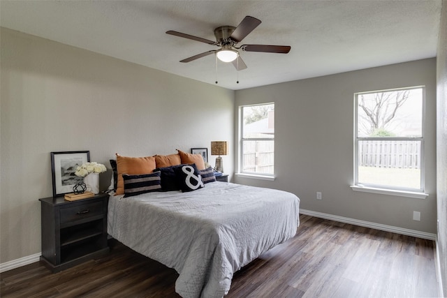 bedroom with baseboards, dark wood-style flooring, and ceiling fan