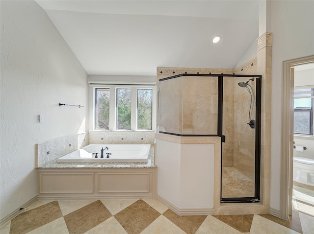 bathroom featuring plenty of natural light, a garden tub, a shower stall, and vaulted ceiling