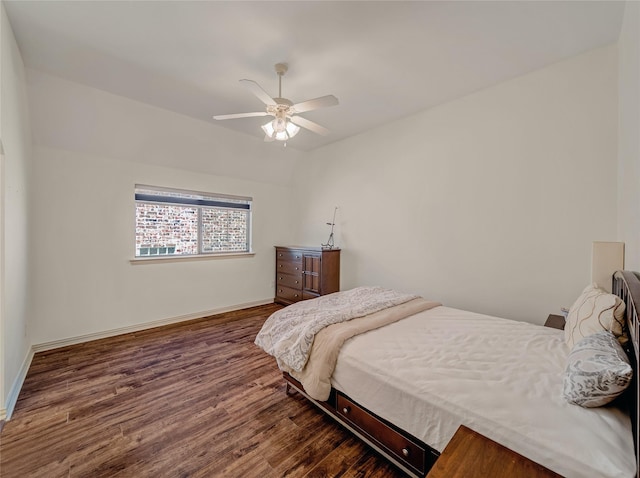 bedroom with a ceiling fan, wood finished floors, and baseboards