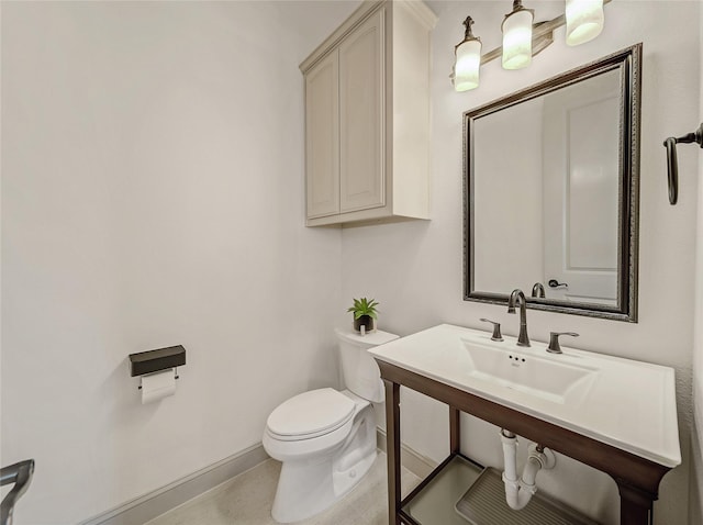 bathroom with toilet and baseboards