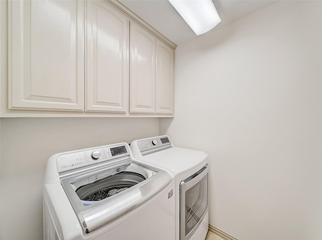 laundry area with cabinet space and washer and clothes dryer