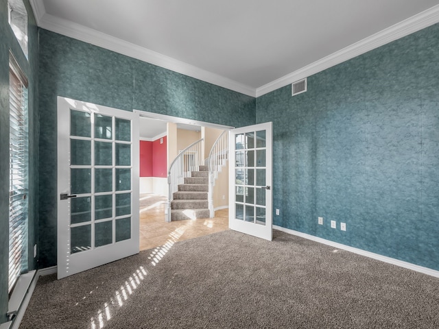 carpeted spare room with ornamental molding, french doors, stairway, wallpapered walls, and baseboards