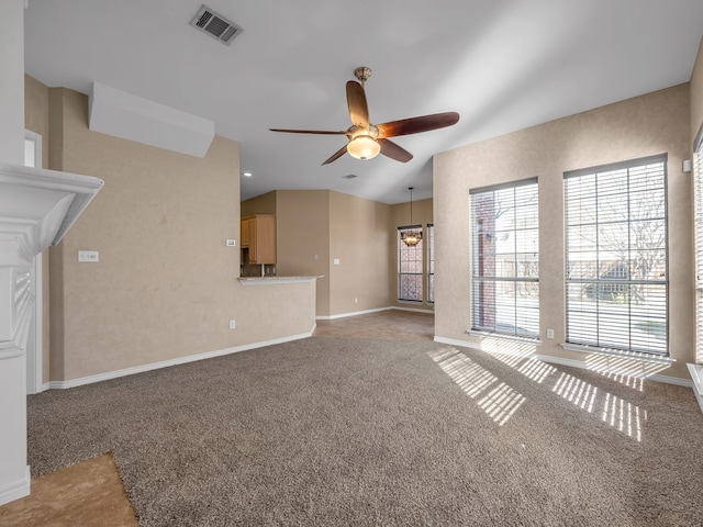 unfurnished living room featuring visible vents, light colored carpet, baseboards, and a ceiling fan