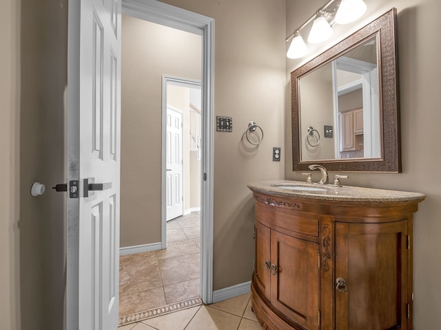 bathroom with tile patterned flooring, vanity, and baseboards