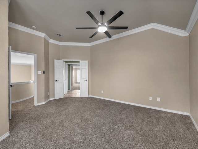 unfurnished bedroom with visible vents, baseboards, carpet, and ornamental molding