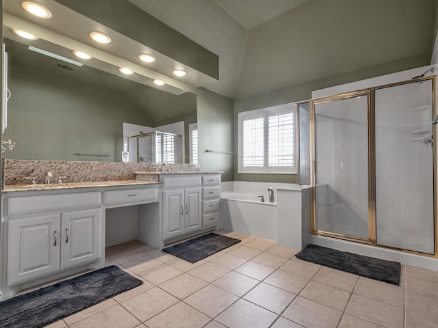 full bathroom featuring double vanity, lofted ceiling, a stall shower, and tile patterned flooring