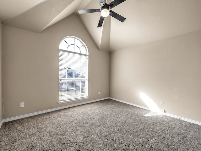 empty room featuring baseboards, lofted ceiling, ceiling fan, and carpet flooring