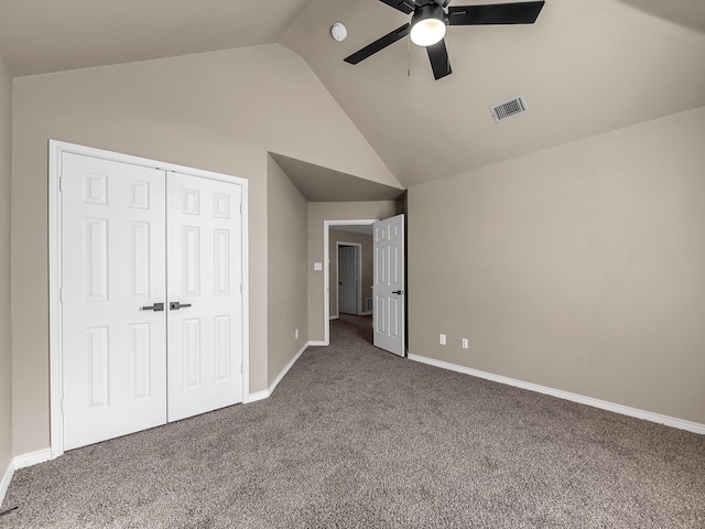 unfurnished bedroom featuring baseboards, visible vents, vaulted ceiling, a closet, and carpet flooring