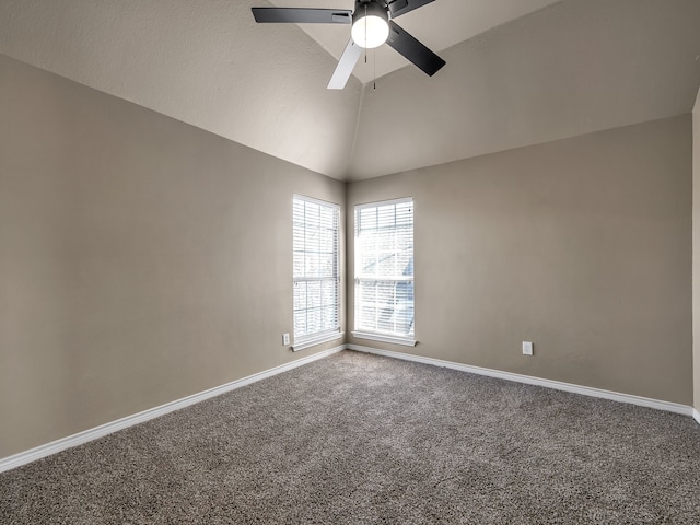 spare room with baseboards, a ceiling fan, carpet, and vaulted ceiling