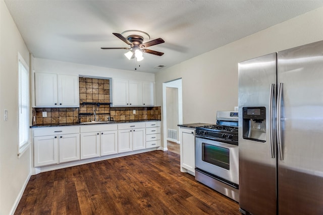 kitchen with backsplash, visible vents, appliances with stainless steel finishes, and a sink