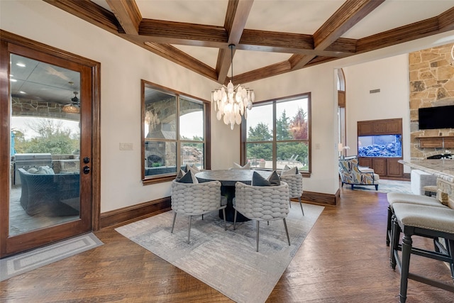 dining room featuring beam ceiling, a notable chandelier, dark wood-style floors, and baseboards