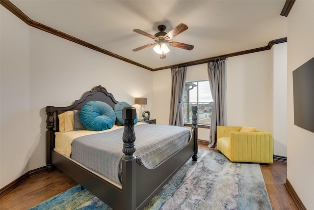 bedroom with crown molding, wood finished floors, baseboards, and ceiling fan