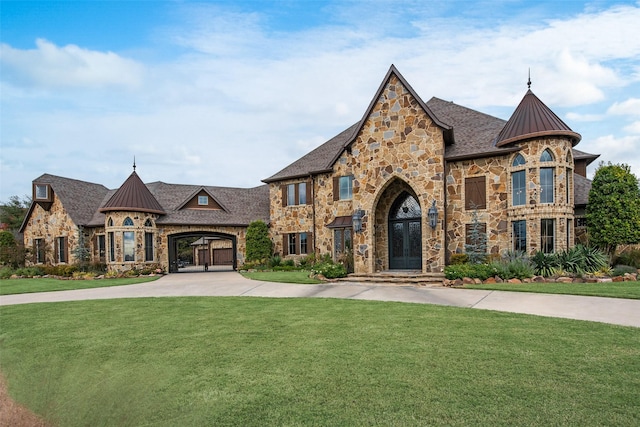 french country home with french doors, a front lawn, a standing seam roof, and metal roof