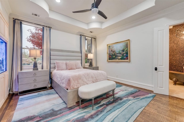 bedroom with recessed lighting, visible vents, a raised ceiling, and crown molding