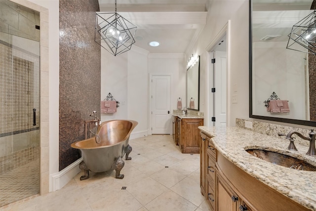 bathroom featuring a shower stall, two vanities, ornamental molding, a freestanding tub, and a sink