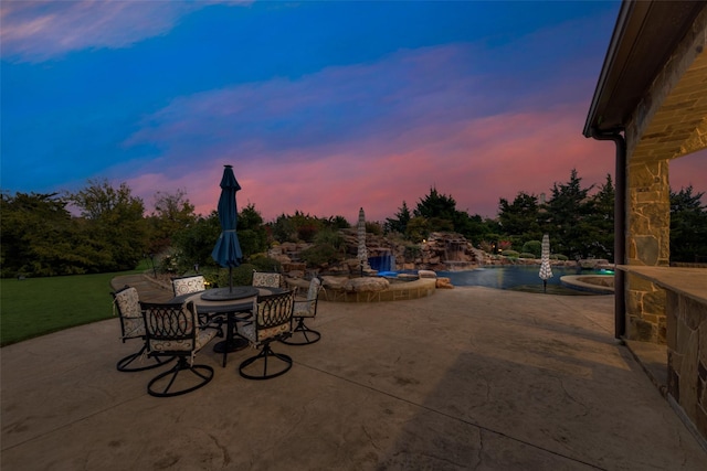 view of patio with outdoor dining space and an outdoor pool