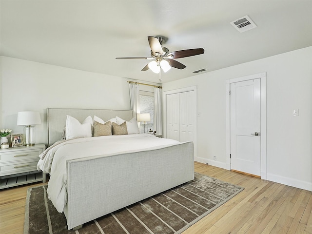 bedroom with a ceiling fan, hardwood / wood-style flooring, baseboards, and visible vents