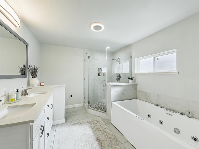 bathroom featuring a shower stall, a jetted tub, marble finish floor, and a sink