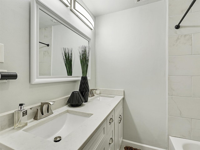 full bathroom featuring double vanity, shower / washtub combination, baseboards, and a sink