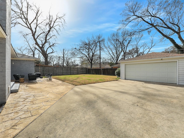 exterior space with a fenced backyard, an outdoor structure, and a garage