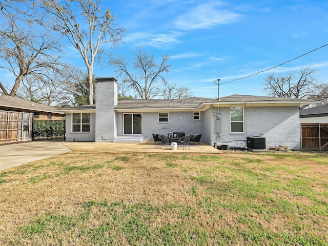 back of property with a patio, central AC, a yard, and fence