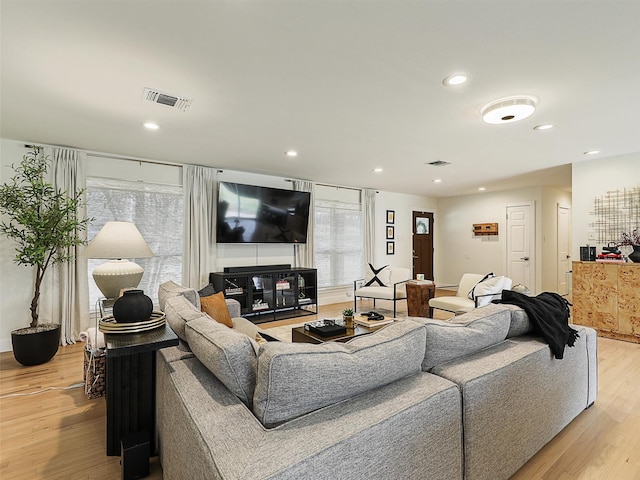 living room featuring visible vents, recessed lighting, and light wood-type flooring